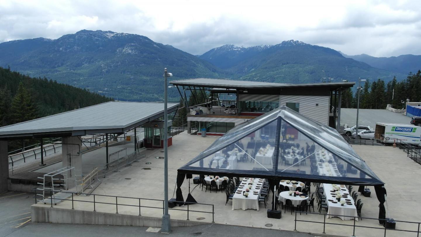 outdoor wedding venue with clear tent over reception area
