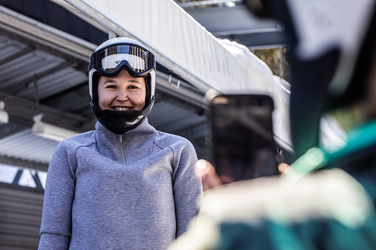 girl smiling for photo with helmet on