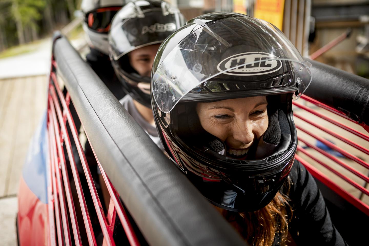 passengers smiling about bobsleigh ride