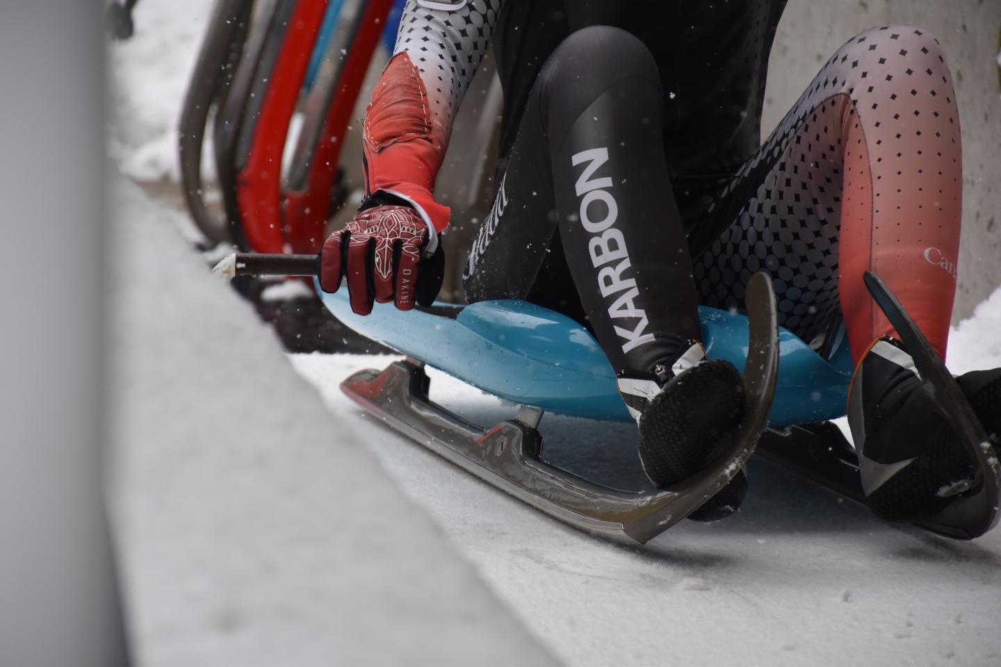 close up of athlete's feet in luge sled