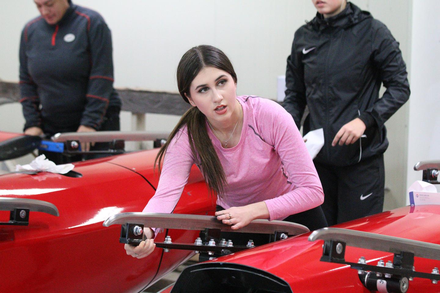 athlete holding bobsleigh handle, working on dry land starts