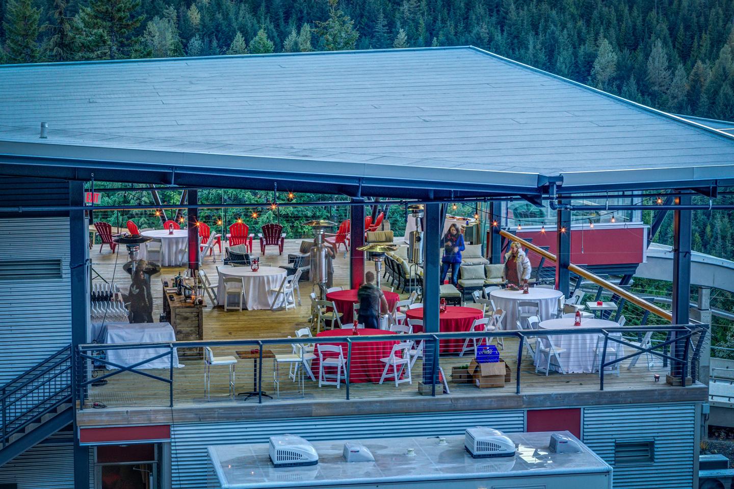 chairs and tables setup on patio at outdoor venue in the mountains