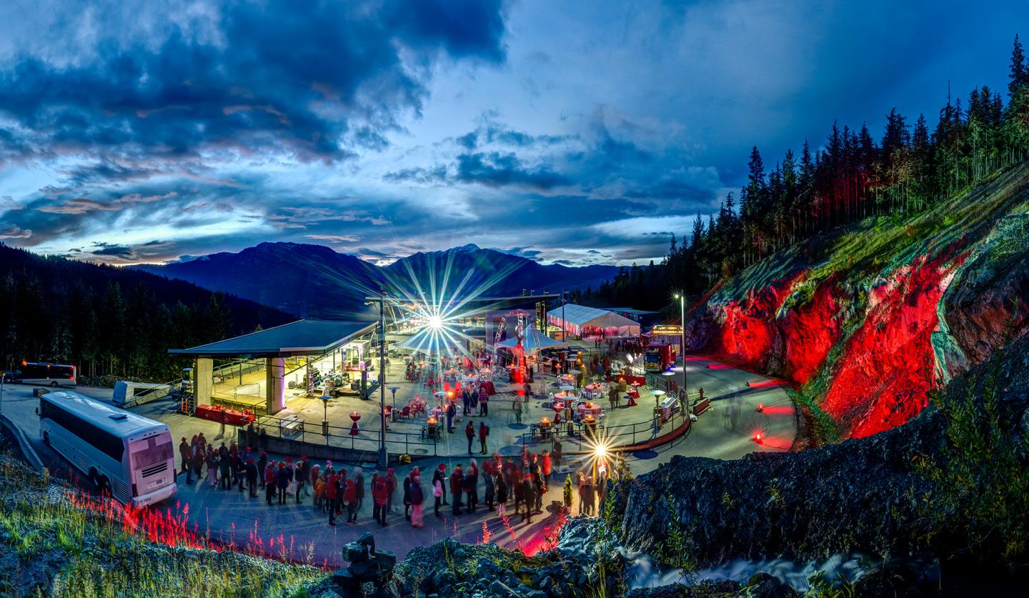 view of event centre lit up for event, in the mountains